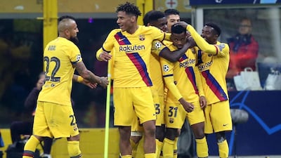 Ansu Fati is mobbed after becoming the youngest goalscorer in Champions League history. EPA