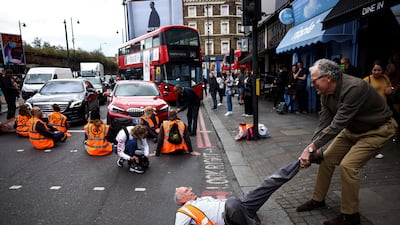 A member of the public dragging an activist who is blocking the road during a Just Stop Oil protest, in London. Taken by Henry Nicholls. Reuters/PA