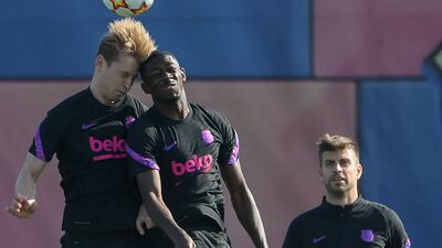Frenkie De Jong, Ousmane Dembele and Gerard Pique train on Tuesday. AFP