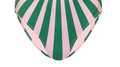 This one-piece by Sun of a Beach certainly makes a style statement, from the retro colours and hypnotic pattern, to the choker-style halter neck; Dh525.00, Sun of a Beach at sanddollardubai.com. Photo: Sun Dollar Dubai