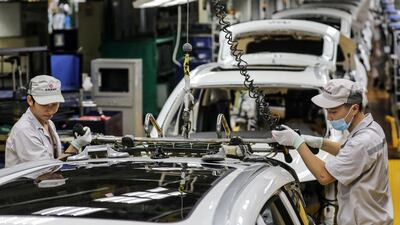 Employees at a car assembly line in Wuhan - the OECD on Wedensday revised upward its global economic contraction forecast on a quicker recovery in China and the US - the world's two largest economies. AFP
