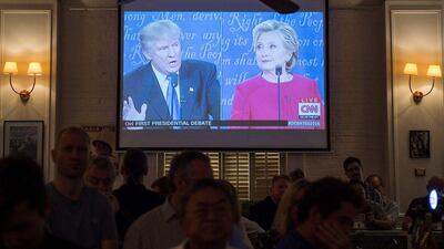 People watch a live projection in Hong Kong on September 27, 2016 as Democratic nominee Hillary Clinton and Republican nominee Donald Trump take part in the first presidential debate. AFP