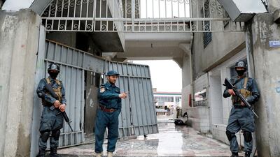 Afghan policemen guard the gate of a Sikh place of worship in Kabul after an attack on March 25, 2020 that was claimed by ISIS. Reuters