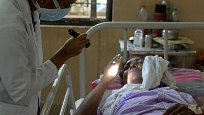 A doctor examines a patient who recovered from Covid-19 and now infected with Black Fungus, a deadly fungal infection, at a ward of a government hospital in Hyderabad. AFP