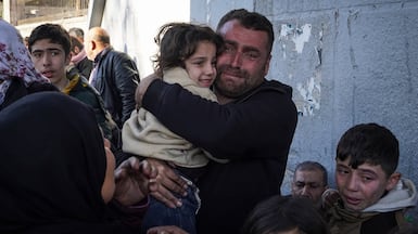 Citizens of the Sheik Maksoud neighbourhood are evacuated to a safe area during the clashes between SDF and Syrian forces in Aleppo, Syria. Getty Images