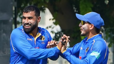 UAE spinner Awais Ali Shah, left, celebrates with Mohammed Rohid after taking a wicket against Oman. Photo: ECB/ICC