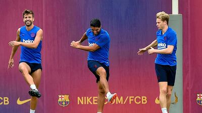 From left: Gerard Pique, Luis Suarez and Frenkie de Jong take part in a warm-up. AFP