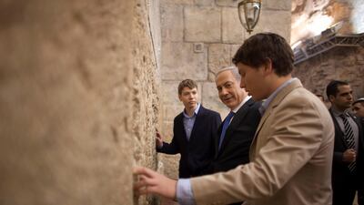 In this Jan. 22, 2013, file photo, Israeli Prime Minister Benjamin Netanyahu, centre, prays with his sons Yair, left, and Avner at the Western Wall. AP