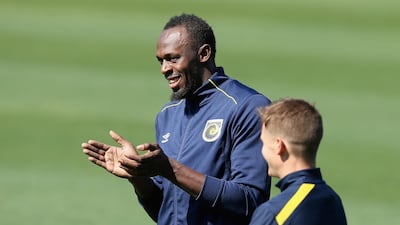 Usain Bolt warms speaks with a teammate. Getty Images