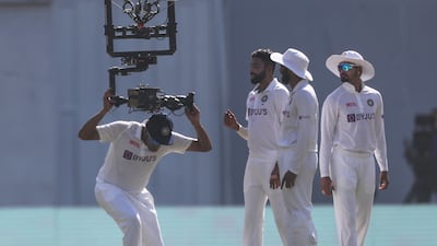 India's Ravichandaran Ashwin, left, grabs a hold of Spidercam. AP