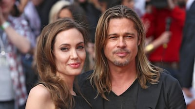 Angelina Jolie poses with Brad Pitt, her partner and star of World War Z, as they arrive for the world premiere of the film. Neil Hall / Reuters