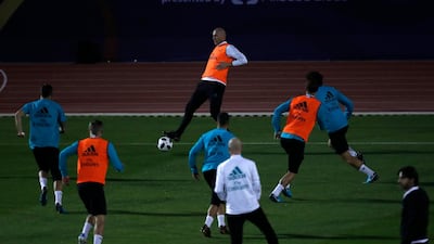 Real Madrid's head coach Zinedine Zidane controls the ball as he trains. Hassan Ammar / AP Photo