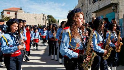 Palestinian scout troops perform during a parade ahead of the arrival of the Relic of the Holy Crib of the Child Jesus at the Church of the Nativity compound in Bethlehem. AFP