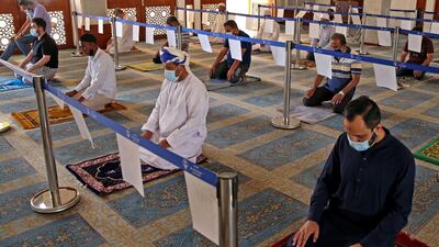 Omani Muslims perform afternoon prayers on the third day of Ramadan at the Abu Bakr Al Siddiq Mosque in Muscat in 2021. This year, taraweeh prayers will only be open in mosques to people who are fully vaccinated. AFP