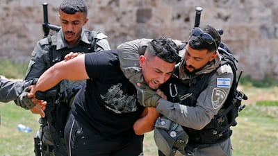 Members of Israeli security detain a Palestinian protester at Damascus Gate in Jerusalem. AFP
