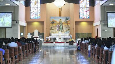 Worshippers view the historic Papal mass at St. Joseph's Cathedral. Khushnum Bhandari for The National