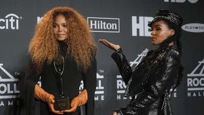Rock and Roll Hall of Fame inductee Janet Jackson, left, holds her trophy as she poses in the press room with Janelle Monae at the induction ceremony at the Barclays Center on Friday, March 29, 2019, in New York. AP
