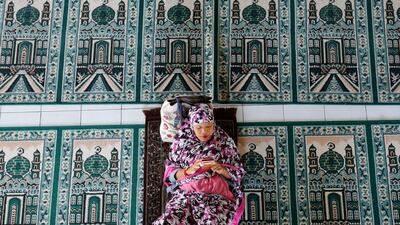 A woman rests at a mosque during the first day of the holy fasting month of Ramadan Monday in Bali, Indonesia. Muslims around the world marked the start of Ramadan on Monday, a month of intense prayer, dawn-to-dusk fasting and nightly feasts. AP Photo