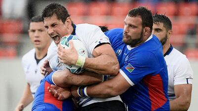 Italy lock Alessandro Zanni, centre, is tackled by Namibia players. AFP