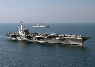 This US Navy photo obtained October 14, 2014 shows the amphibious assault ship USS Makin Island (LHD 8) as it pulls alongside the aircraft carrier USS George H.W. Bush (CVN 77) for a vertical replenishment on October 10, 2014 in the Gulf. AFP