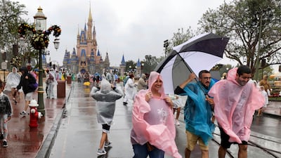 Guests brave the weather in the Magic Kingdom at Walt Disney World in Lake Buena Vista, Florida. AP