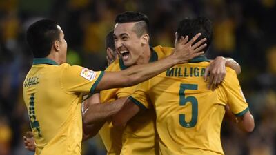 Jason Davidson of Australia, centre, celebrates with teammates after scoring against UAE on Tuesday in the Asian Cup semi-final. Peter Parks / AFP