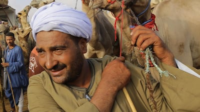 A herdsman pulls a camel to Birqash Camel Market.