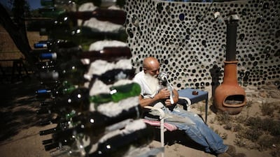 Artist Roy Lohr sits in a “spaceship” he built in his backyard from wine and beer bottles in Truth or Consequences, New Mexico. Lucy Nicholson / Reuters