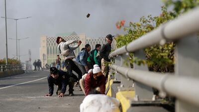 Indonesian protesters throw stones during a clash with police in Jakarta, Indonesia. EPA