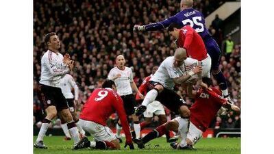 Pepe Reina, right, the Liverpool goalkeeper, punches the ball away during their 1-0 FA Cup third-round defeat to Manchester United on Sunday. Alex Livesey / Getty Images