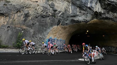 The peloton cycles through a mountain tunnel on Stage 5. AFP
