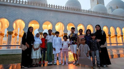 Worshippers pose for a photo before iftar at the Sheikh Zayed Grand Mosque in Abu Dhabi. Victor Besa / The National
