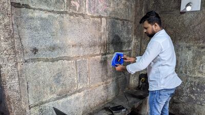 A team member 3D-scans a 10th-century inscription on the wall of a temple at Kudlur Channapatna. Photo: PL Udaya Kumar