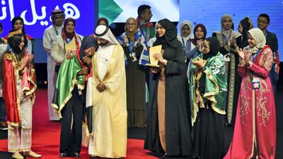 Sudanese Hadeel Anwar is comforted by Sheikh Mohammed bin Rashid as she reacts after being announced winner of the 2019 Arab Reading Challenge in Dubai, UAE. Shruti Jain for The National