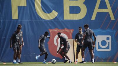 Barcelona's players Ansu Fati , Nelson Semedo and Luis Suareztake part in a training sessio. EPA