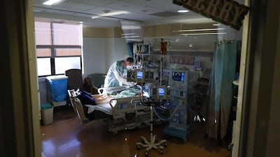 Respiratory therapist Andrew Hoyt cares for a Covid-19 patient in the Intensive Care Unit at Sharp Chula Vista Medical Centre in California on December 21. AFP