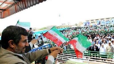 A handout picture released by Iranian President Mahmoud Ahmadinejad's official website shows Ahmadinejad waving at supporters during a visit to the island of Abu Musa on April 11, 2012.