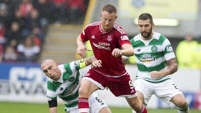 Adam Rooney, centre, has scored five goals in the first six games this season to help Aberdeen to the top of the Scottish Premiership. Jeff Holmes / PA