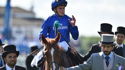 Jockey William Buick gestures as he returns to the winner's enclosure on Masar after his victory at the Epsom Derby. Glyn Kirk / AFP