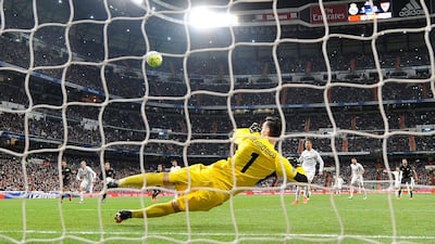 Cristiano Ronaldo of Real Madrid has his penalty kick saved by Sergio Rico of Sevilla FC to score Real’s 2nd goal during the La Liga match between Real Madrid CF and Sevilla FC at Estadio Santiago Bernabeu on March 20, 2016 in Madrid, Spain. (Photo by Denis Doyle/Getty Images)