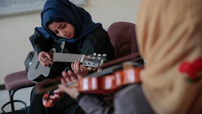 A female Yemeni music student practices playing the guitar during a music class at the Cultural Centre in Sanaa, Yemen. Hani Mohammed / AP Photo