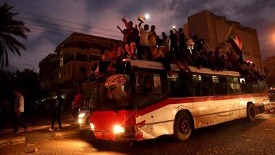 Sudanese people gather on a bus as they celebrate. EPA/MORWAN ALI