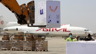 Workers handle the first batch of doses of the AstraZeneca vaccine against the coronavirus disease at Aden International Airport, Yemen. Reuters