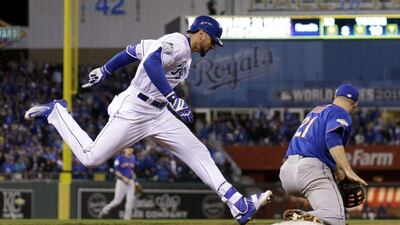 Kansas City Royals player Paulo Orlando lunges to first base during Game 1 of the World Series against the New York Mets on Tuesday night. David J Phillip / AP / October 27, 2015