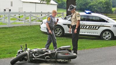 A Virginia State trooper and a Rockingham County sheriff's deputy investigate the scene of a motorcycle/pickup truck collision in eastern Rockingham County. The advent of driverless cars will make motocycling much safer which will in turn boost motobike sales.Bryan Gilkerson / AP
