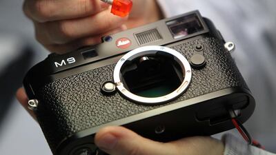 A mechanic cleans the sensor of a Leica M9 camera at the production facility of Leica in Solms, western Germany. Daniel Roland / AFP