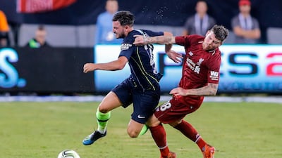 Liverpool's Alberto Moreno vies for the ball with Manchester City's Bernardo Silva. AFP