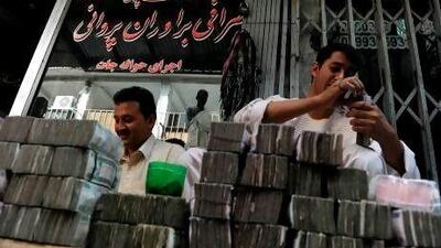 Money changers count bundles of bank notes in Kabul last year.