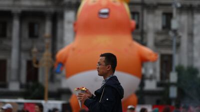 The 'Baby Trump' balloon was first seen in the skies above London, travelled to France and is now on display in the streets of Buenos Aires. Reuters