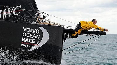 Ian Walker, the Abu Dhabi Ocean Racing skipper, works on the lines at the bow as Azzam sets sail from Alicante to Cape Town.
